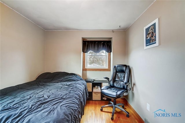 bedroom featuring wood finished floors