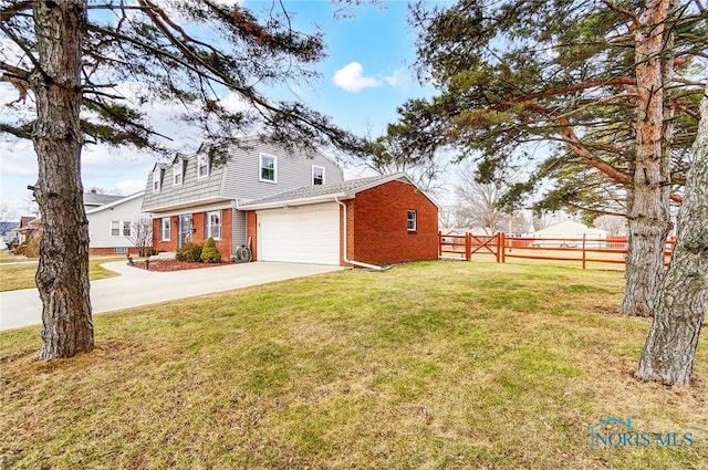 exterior space with brick siding, concrete driveway, a lawn, fence, and a garage