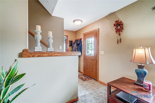 entrance foyer with stairway and baseboards