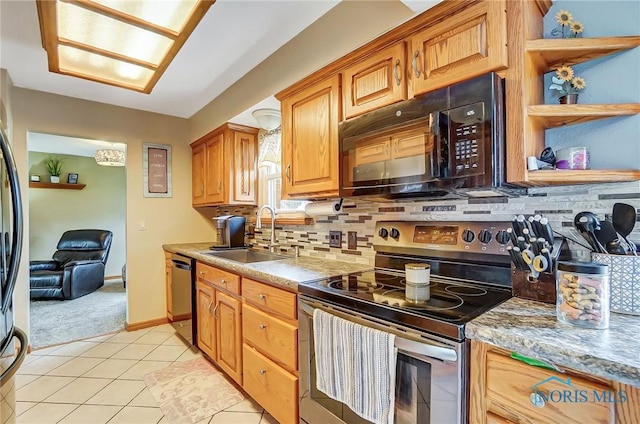 kitchen with decorative backsplash, dishwasher, stainless steel range with electric cooktop, black microwave, and a sink