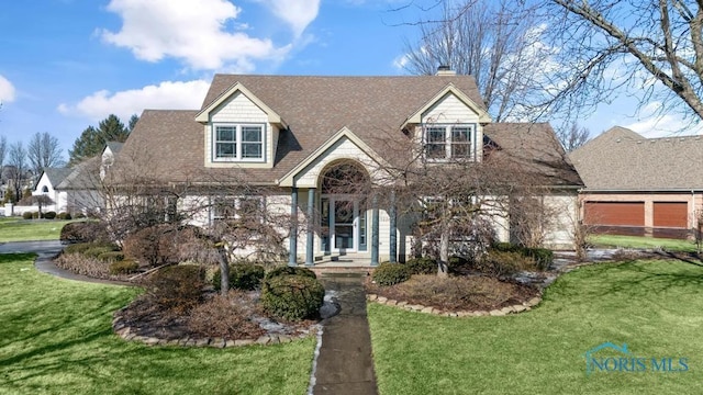 cape cod-style house featuring roof with shingles, a front lawn, and a chimney