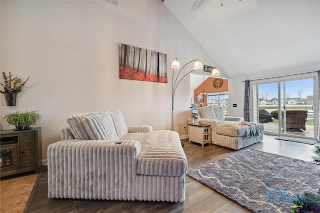 interior space with high vaulted ceiling, wood finished floors, a ceiling fan, and baseboards