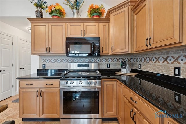 kitchen with black microwave, dark stone countertops, decorative backsplash, and stainless steel gas stove