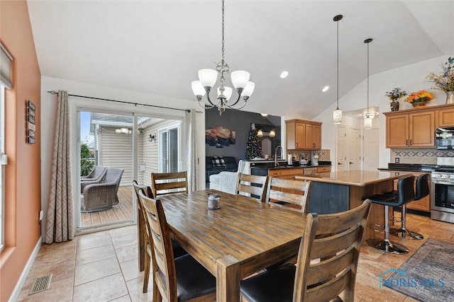 dining space with a chandelier, lofted ceiling, visible vents, and baseboards