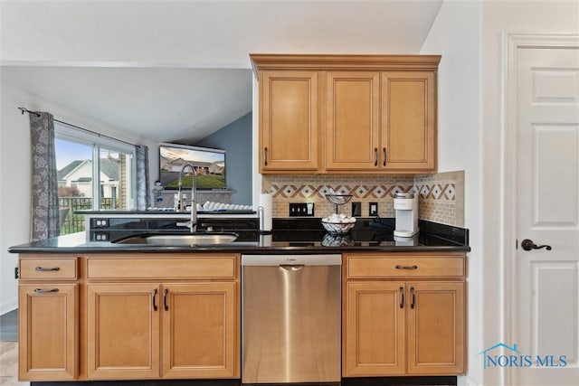 kitchen with decorative backsplash, vaulted ceiling, a sink, dark stone counters, and dishwasher