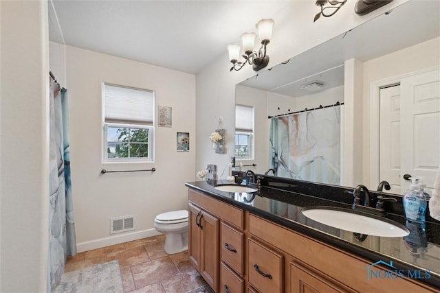 full bathroom featuring toilet, baseboards, visible vents, and a sink