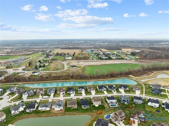 birds eye view of property with a water view and a residential view