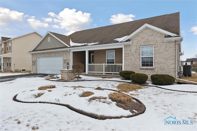 view of front of home with a garage, a porch, brick siding, and central air condition unit