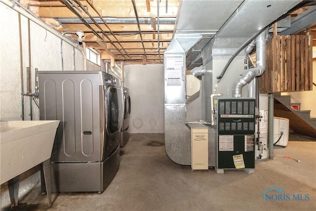 unfinished basement with washer and clothes dryer and a sink