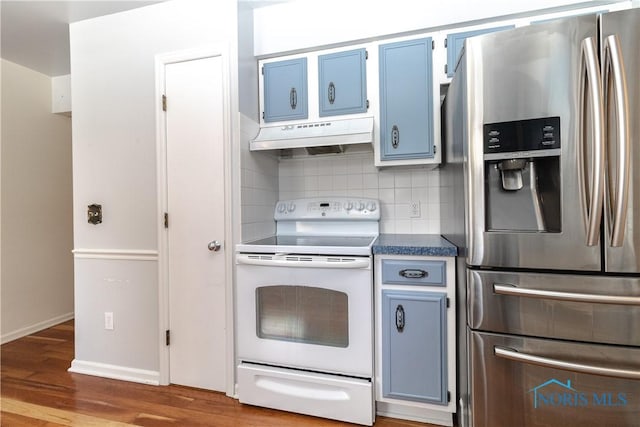 kitchen with white electric range oven, backsplash, wood finished floors, stainless steel fridge, and under cabinet range hood