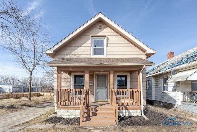 view of front of house featuring a porch and roof with shingles