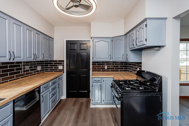 kitchen with gray cabinets, wooden counters, and black appliances