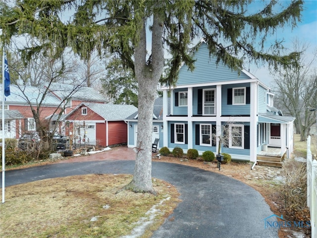 greek revival house with driveway and an attached garage