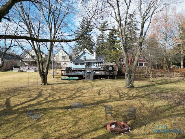 view of yard with a fire pit and a deck