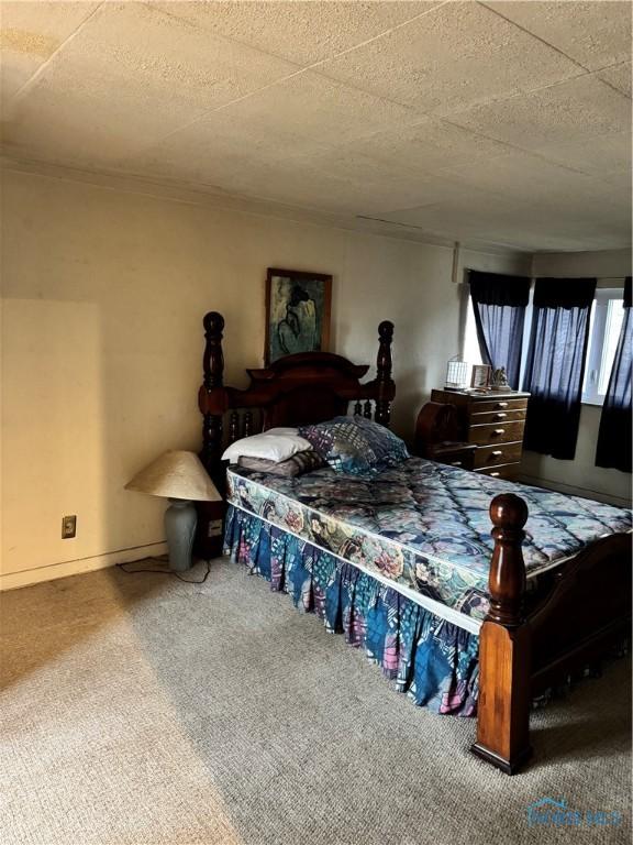 carpeted bedroom featuring a textured ceiling