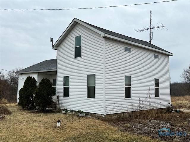 view of side of home featuring a lawn