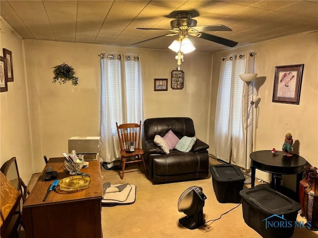 sitting room featuring a ceiling fan and light carpet