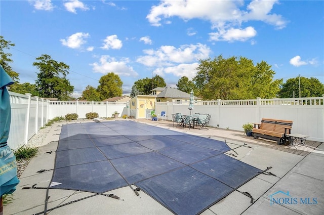 view of swimming pool with a patio area and a fenced backyard