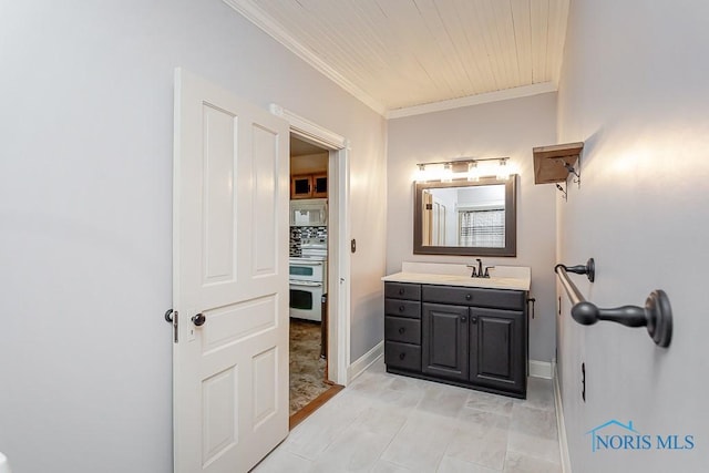 bathroom featuring ornamental molding, baseboards, backsplash, and vanity