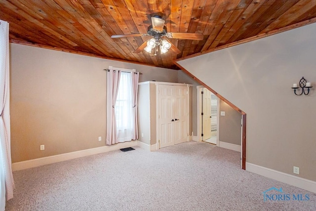 bonus room featuring light colored carpet, visible vents, wood ceiling, ceiling fan, and baseboards