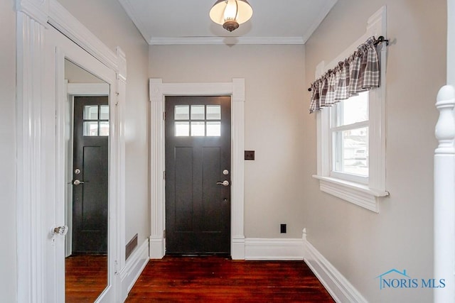 entrance foyer featuring dark wood-style floors, baseboards, and ornamental molding