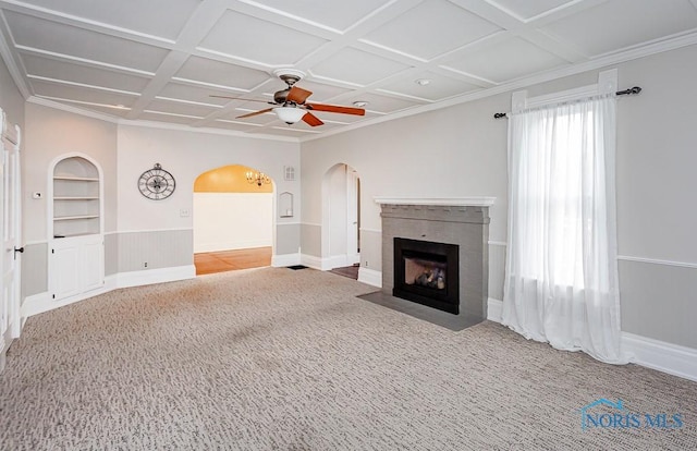 unfurnished living room featuring arched walkways, built in shelves, light carpet, a fireplace, and coffered ceiling