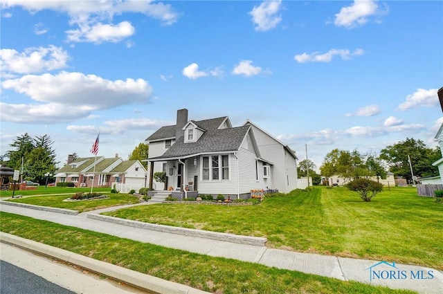 view of front of property with a shingled roof, a residential view, a chimney, and a front lawn