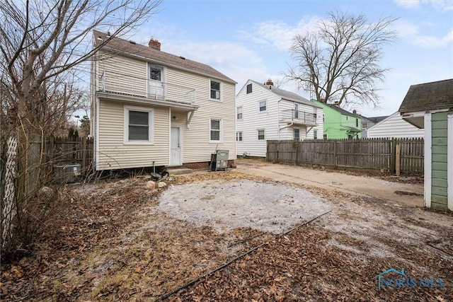 rear view of property featuring fence private yard and a chimney