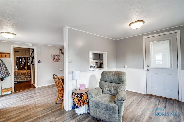 sitting room featuring a textured ceiling and wood finished floors