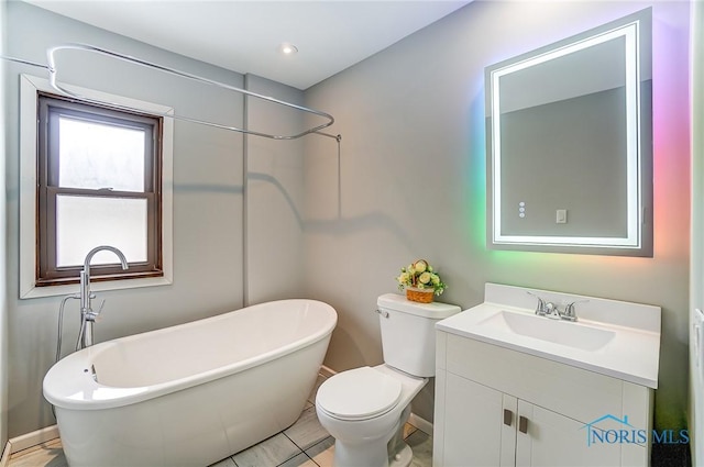 full bathroom with toilet, a soaking tub, and vanity