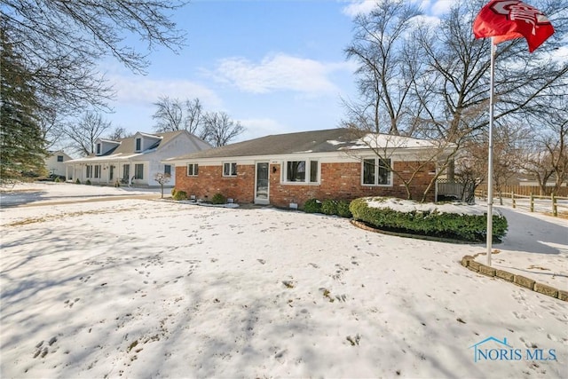 view of front of home with fence and brick siding