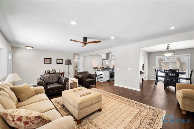 living room featuring recessed lighting, dark wood finished floors, baseboards, and ceiling fan