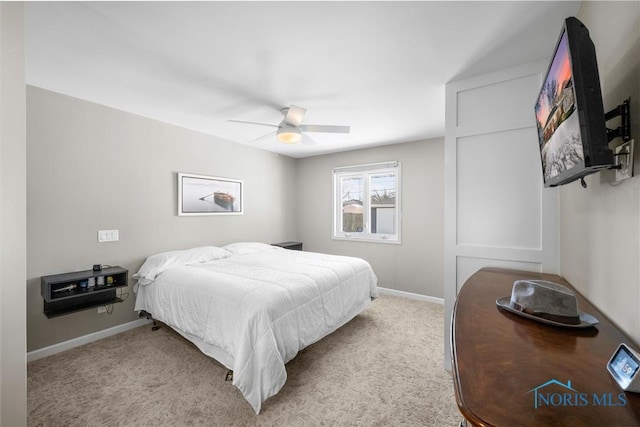 bedroom featuring baseboards, a ceiling fan, and light colored carpet