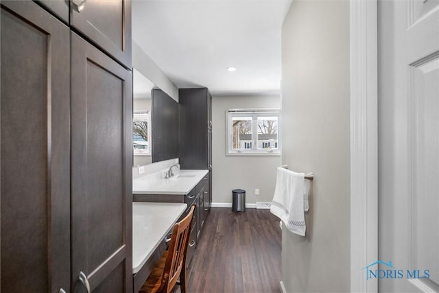 bathroom featuring recessed lighting, wood finished floors, vanity, and baseboards