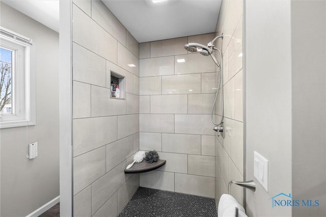 bathroom with a tile shower