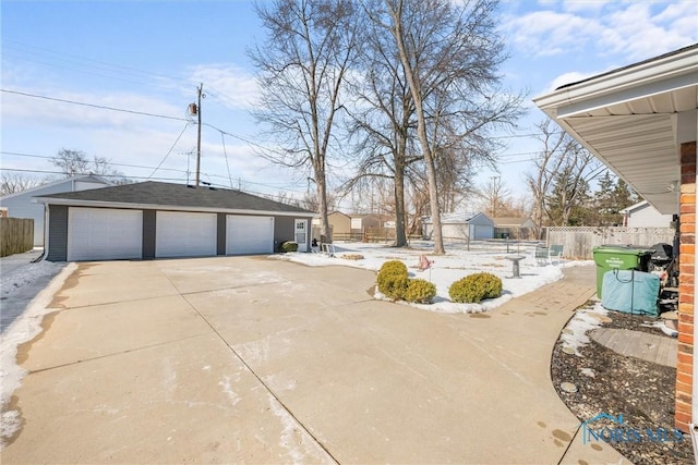 view of yard with a garage, fence, and an outdoor structure