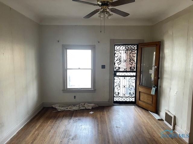 entrance foyer with ceiling fan, wood finished floors, visible vents, and baseboards