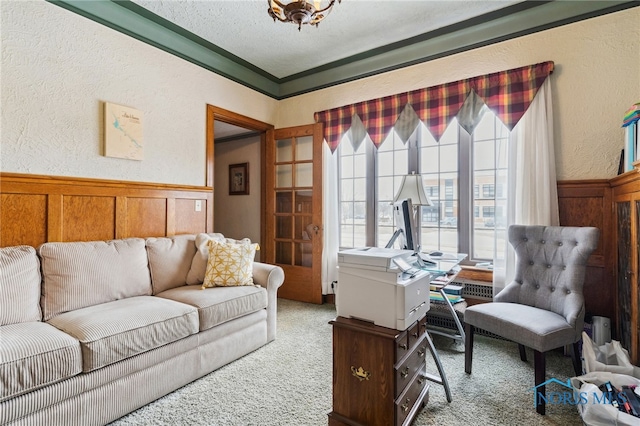 office space with carpet floors, a wainscoted wall, a textured wall, and a textured ceiling