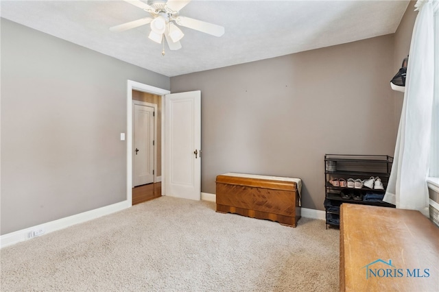 bedroom featuring a ceiling fan, light carpet, and baseboards