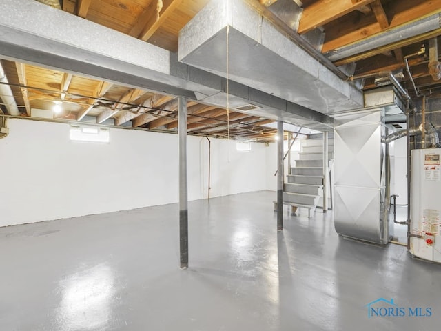 basement with water heater, heating unit, and stairs