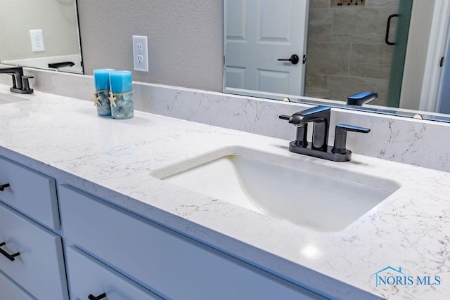 room details featuring a textured wall and vanity