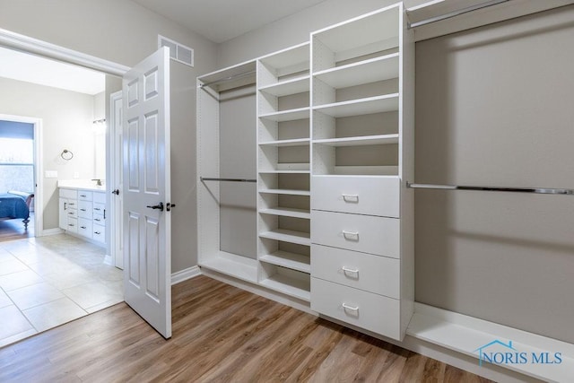 walk in closet featuring visible vents and light wood-style floors