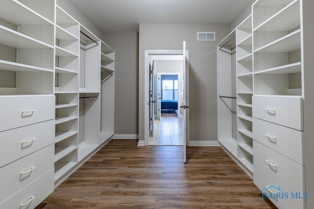 walk in closet featuring dark wood-style floors and visible vents