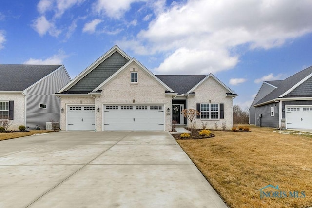 view of front of house featuring concrete driveway, brick siding, and a front lawn