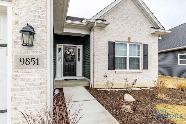 property entrance with brick siding