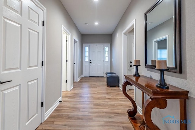 interior space featuring light wood-style flooring and baseboards