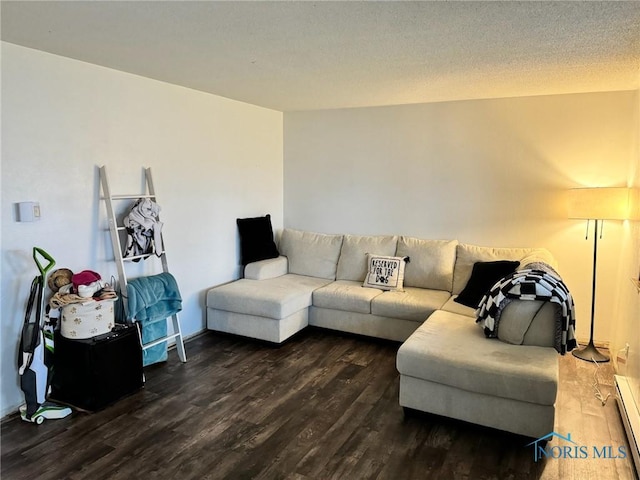 living area featuring a baseboard radiator, dark wood finished floors, and a textured ceiling