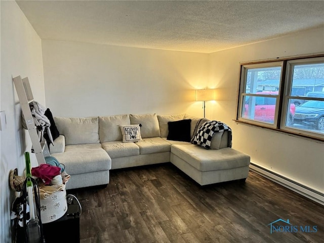 living area featuring a baseboard radiator, dark wood finished floors, and a textured ceiling