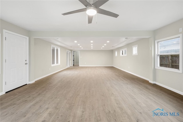 interior space with ceiling fan, recessed lighting, light wood-type flooring, and baseboards