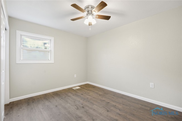 empty room with visible vents, baseboards, ceiling fan, and wood finished floors